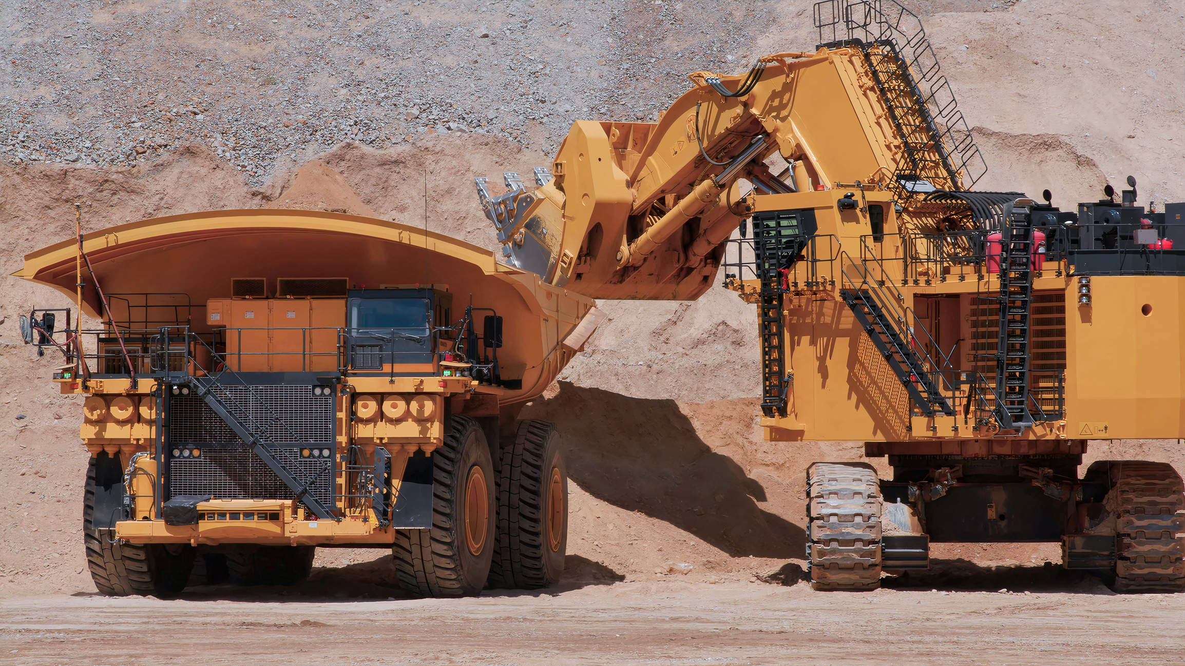 heavy mining machinery extracting minerals in an open pit mine